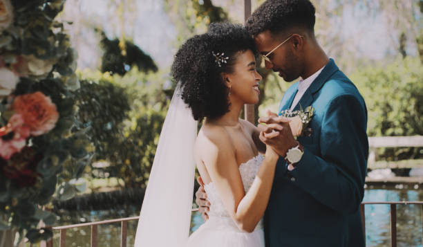 A couple embracing in front of a pond